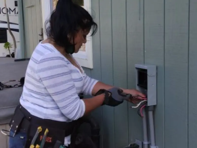 Licensed electrician wiring an exterior subpanel in Monterey